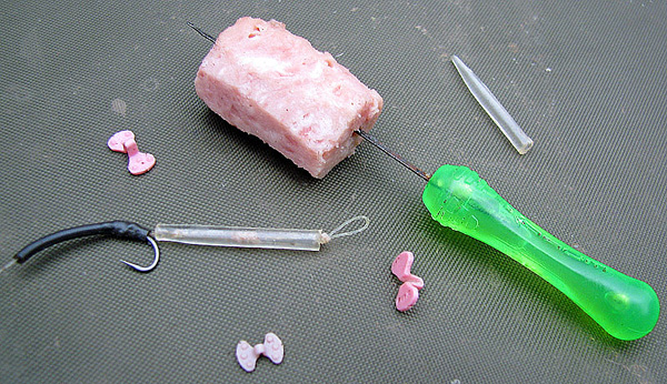 Fox luncheon meat props really help keep cubes of meat on hair rigs.  Here you can see both the high surface area prop and the silicone hair sleeve