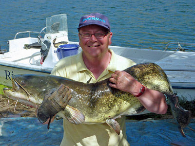Dave Newby-Thornley displays his 50lb catfish - the largest fish he's ever landed