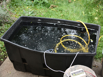 Far better is to get a large bucket and invest in an aerator pump