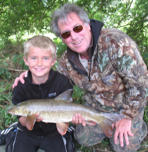 What it's all about! Lewis and me with his first barbel.
