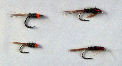 Diawl Bachs.  My deconstructed versions are on the left.  The top one is tied on a size 10 carp hook and the bottom one on a size 14 wet fly hook.  I trim the peacock after tying to give a slimmer body.  The ones on the right are shop bought.  The bottom one has been slimmed by repeated contact with trouts