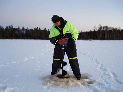 Drilling the holes with a motor driven ice-auger