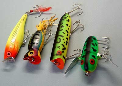 Left to right, Rapala Skitter Pop, Arbogast Hula Popper, Heddon Lucky 13, and the Heddon Crazy Crawler