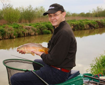 A commercial carp and a happy angler