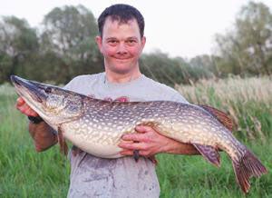 Alex with a 24.08 pike caught on a wagtail